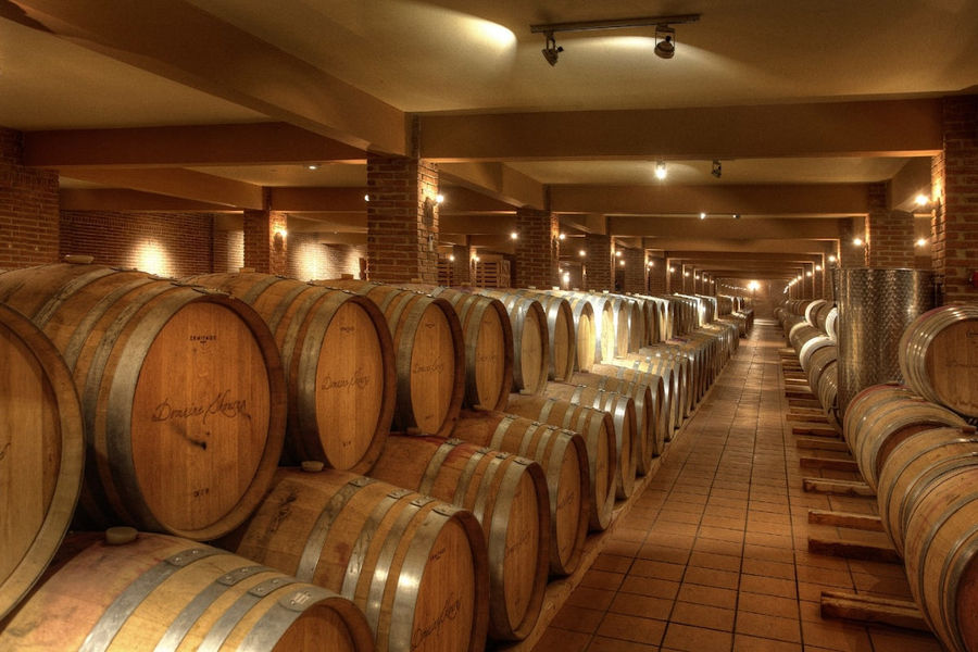 wine wood barrels on top of each other at 'Domaine Skouras' cellar
